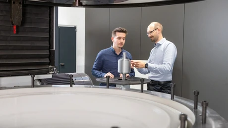 Colleagues next to the spin test system with a rotor
