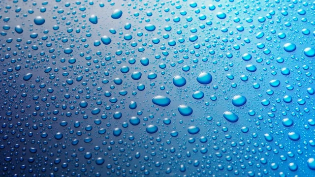 Panoramic banner of water drops on blue metal