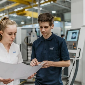 Vocational training at the Dürr Group Two apprentices of Dürr looking at a plan.