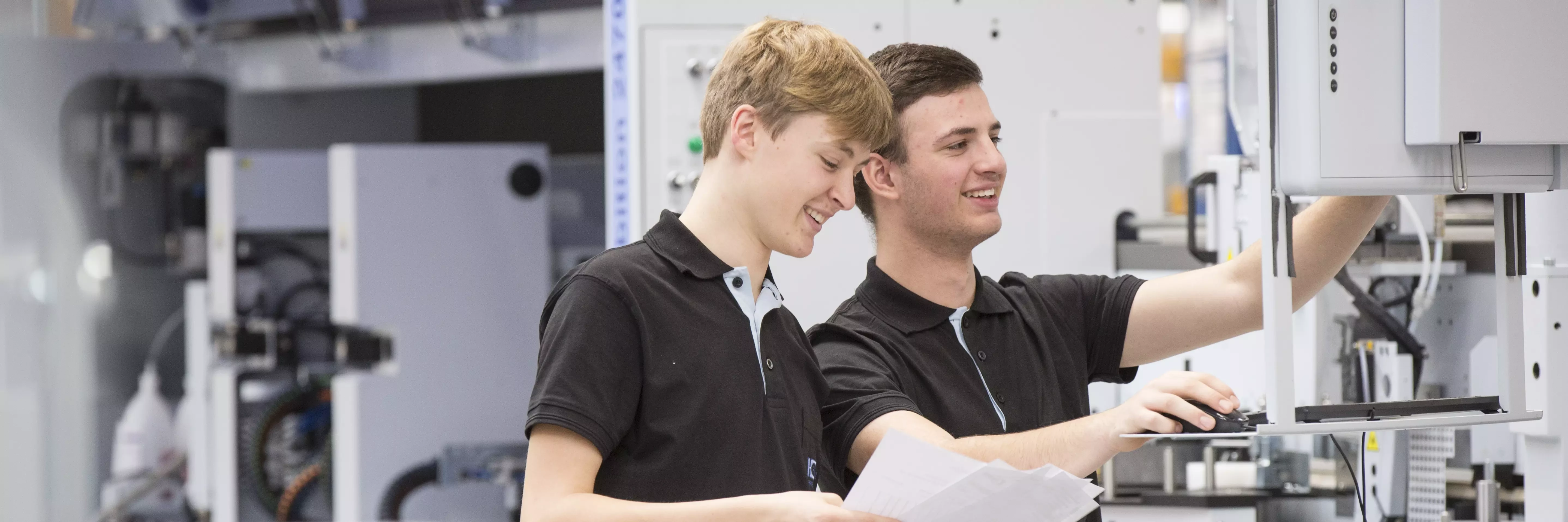 Vocational Training apprentices working on a machine